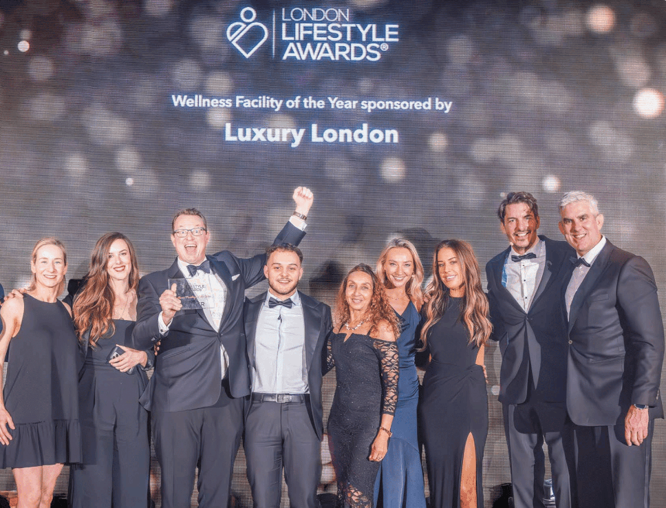 The Biowell team on stage at the London Lifestyle Awards holding the Wellness Facility of the Year trophy